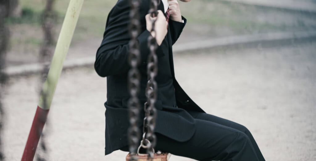 ブランコに乗る男性